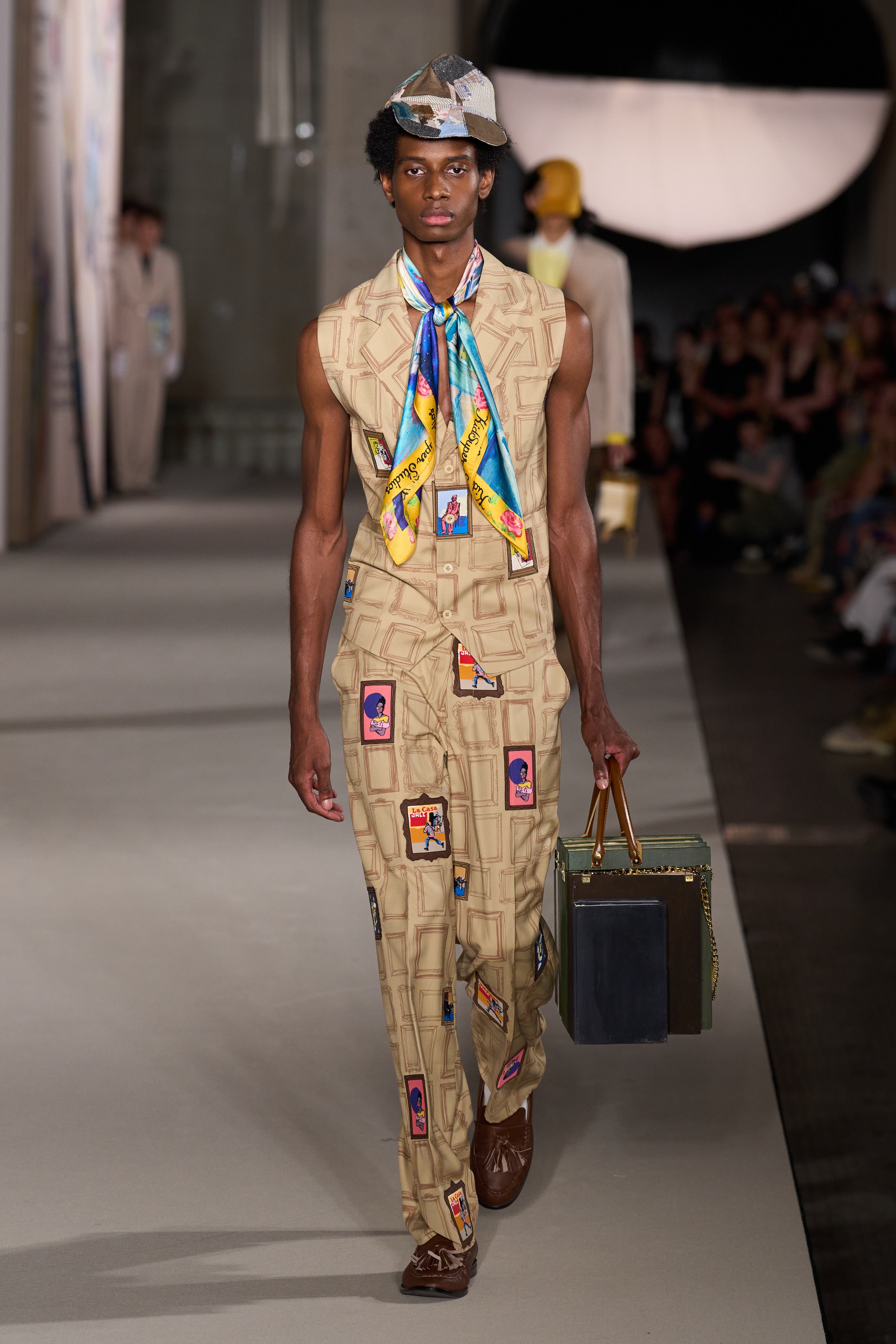 Image may contain Fashion Clothing Scarf Accessories Bag Handbag Adult Person Standing Footwear and Shoe